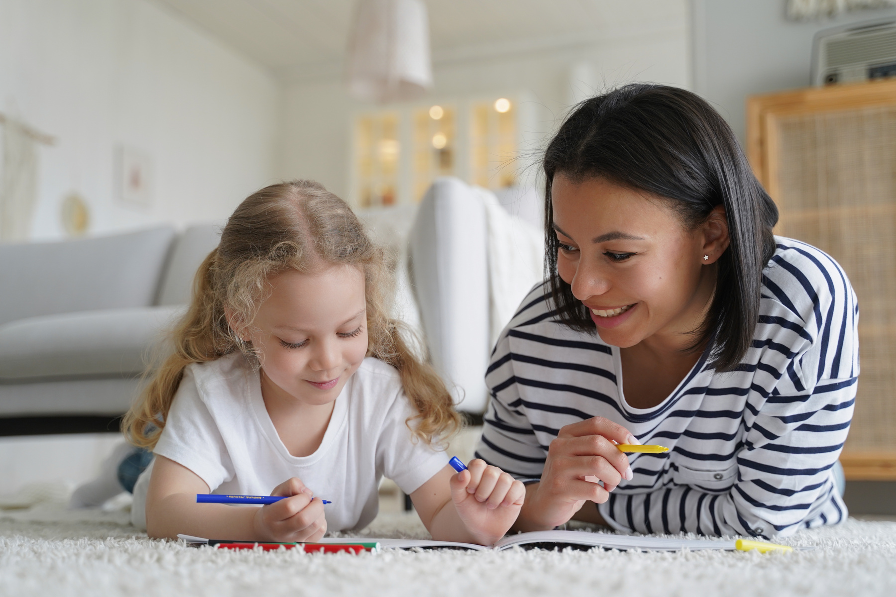 Mom and little foster daughter drawing painting together, ly